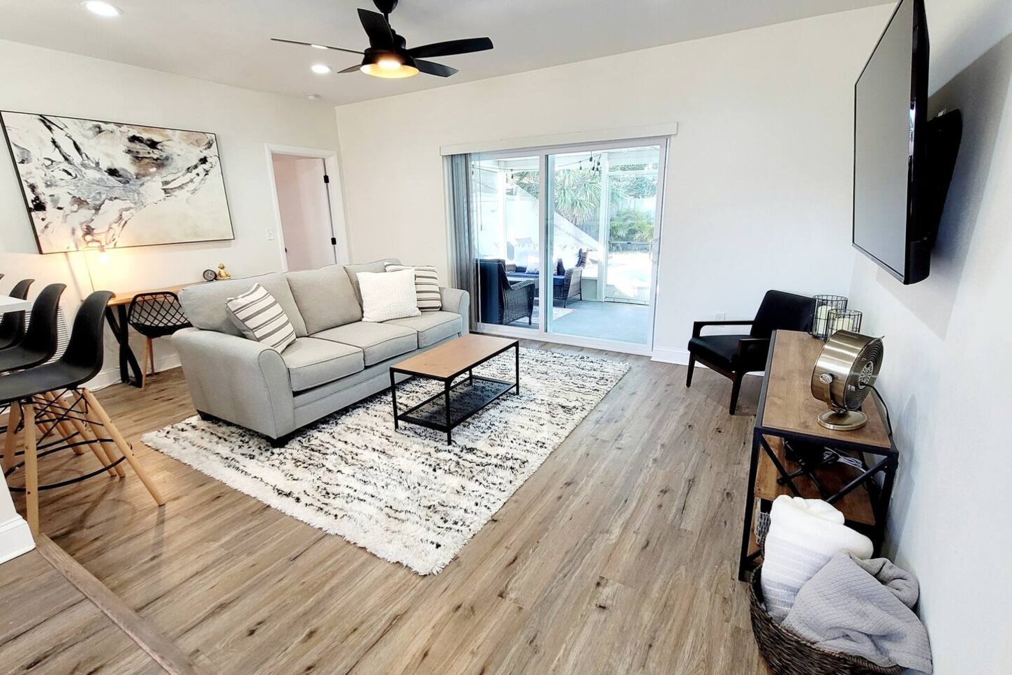 The living room is cozy and functional. A 65 inch smart TV will keep anyone entertained and a desk to make sure your out of office is turned on. 