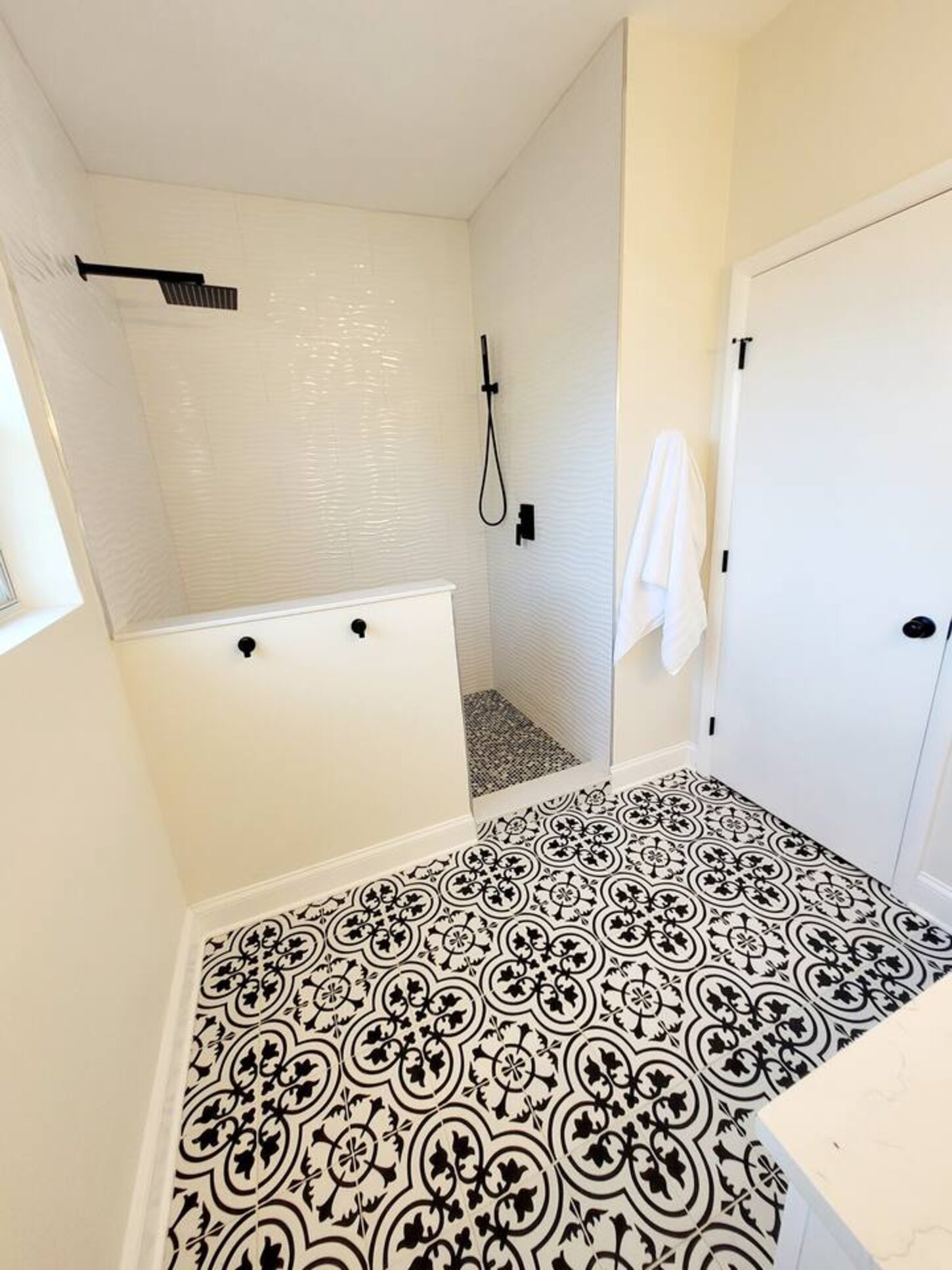 The walk in shower has both a rain shower and removable wand shower head.