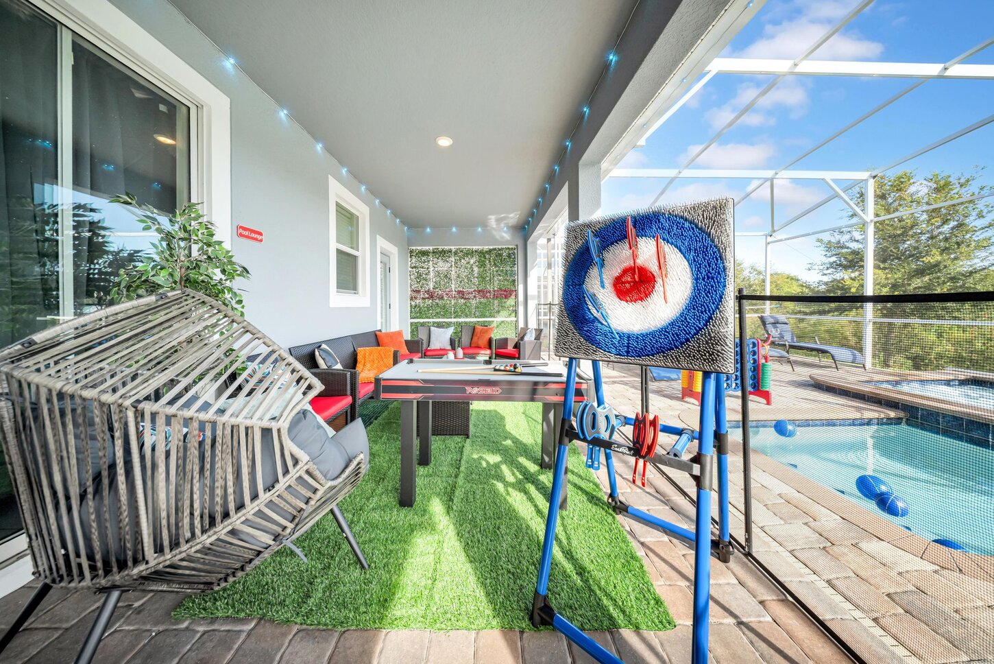  Entertainment and relaxation come together here. Challenge friends with  Connect 4,  axe throwing, or a game of  pool. Unwind in the cozy  egg chair, stretch out on the  loungers, or relax under the  umbrella.