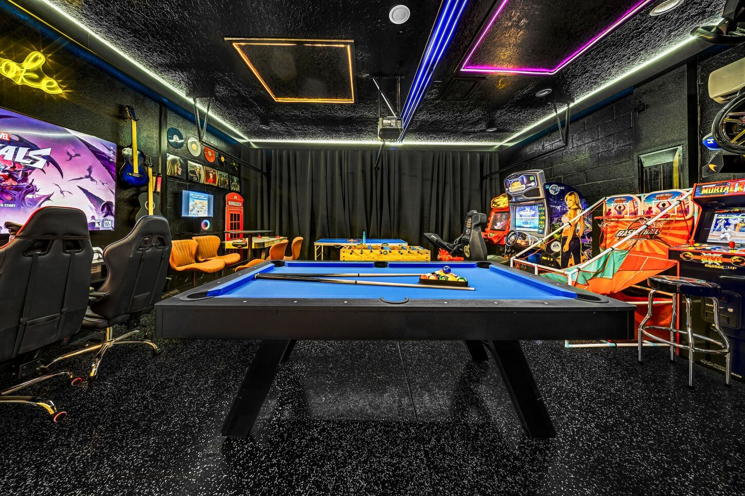  A stylish game room with  mural art, modern seating, and top consoles   designed for unforgettable play and socialworthy photos .  