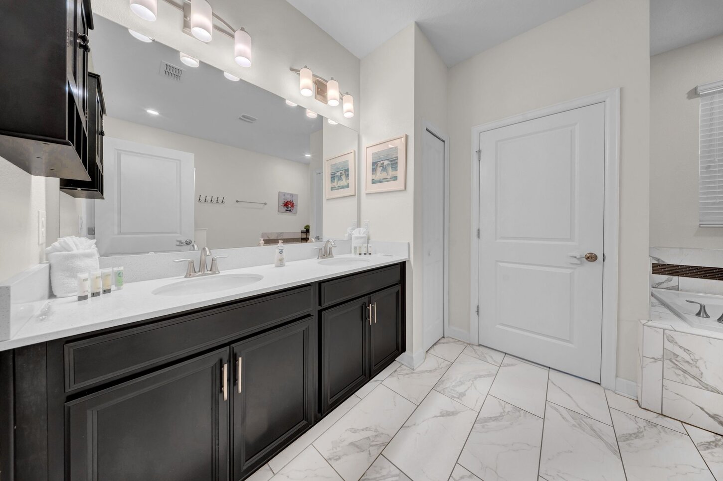  Indulge in a spotless bathroom featuring a sparkling tub, offering the perfect place to refresh, recharge, and unwind.
