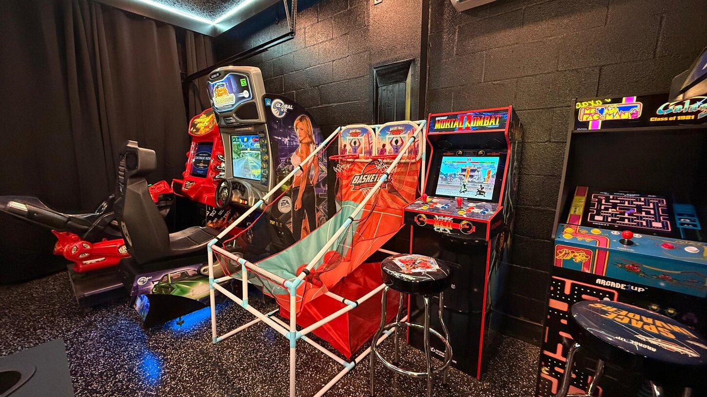 A gamers dream room  Enjoy car racing , bike arcade , kart car , arcade classics like Mortal Kombat   PacMan , plus basketball .