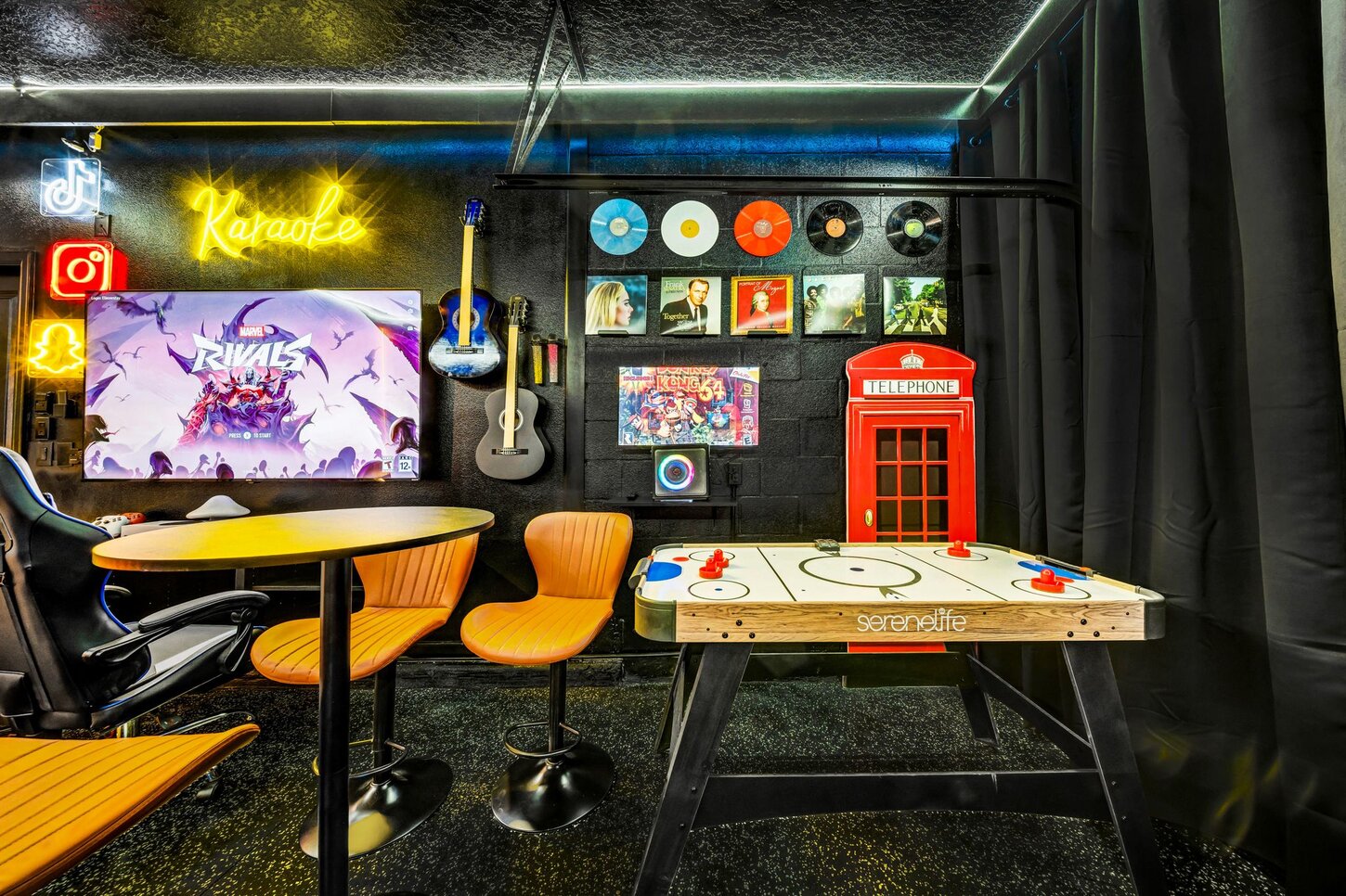 Karaoke nights,  a retro telephone booth,  microphone, and  guitar  the perfect setup for music lovers.