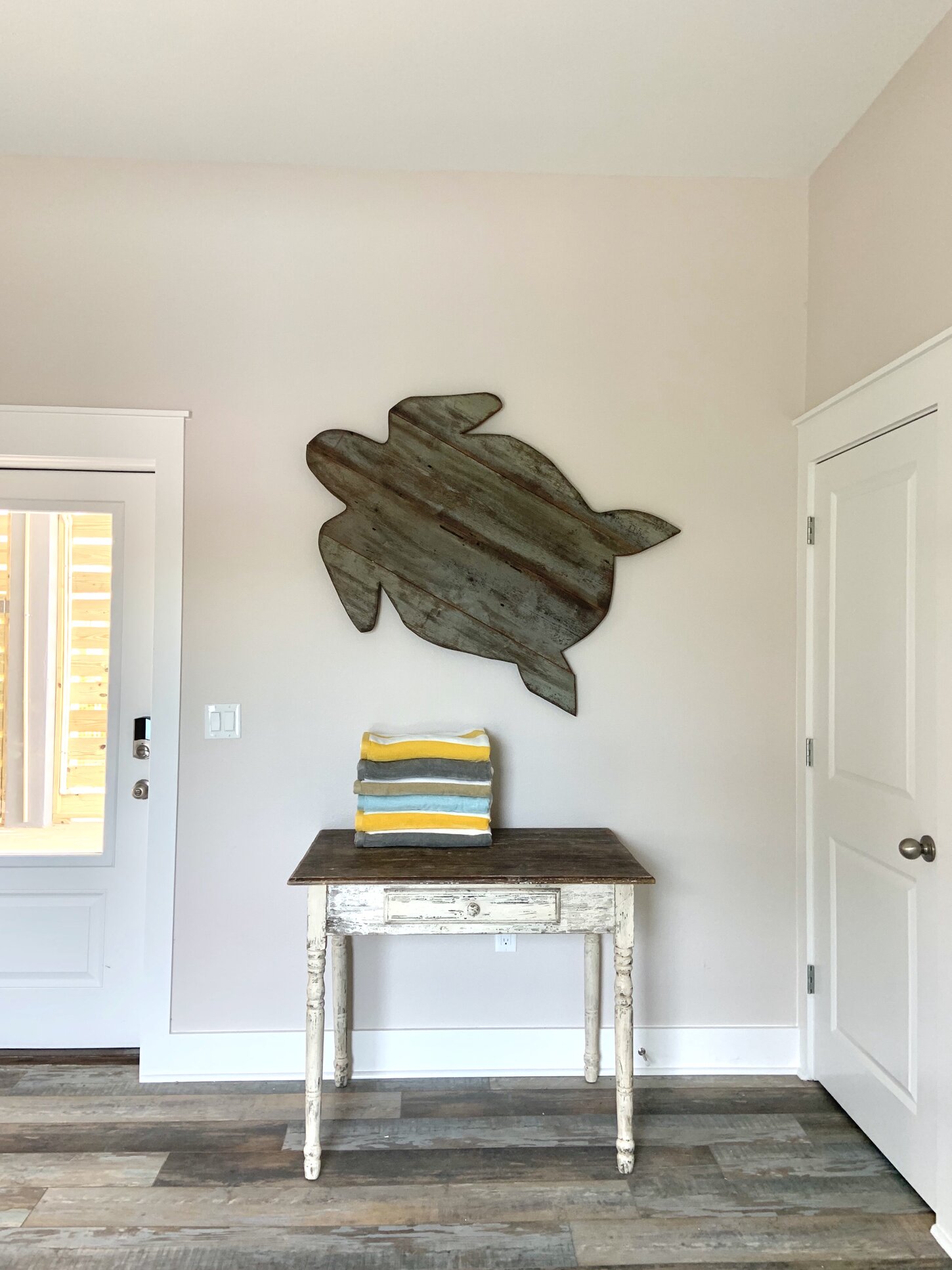 Ground floor elevator lobby.  Turtle made by owner using reclaimed wood from a beloved family member