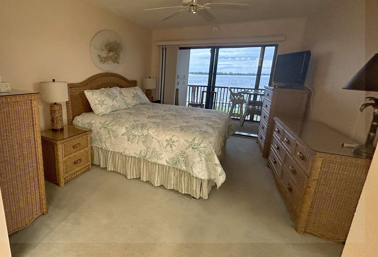 King bed in master bedroom with private lanai and view of Sarasota Bay