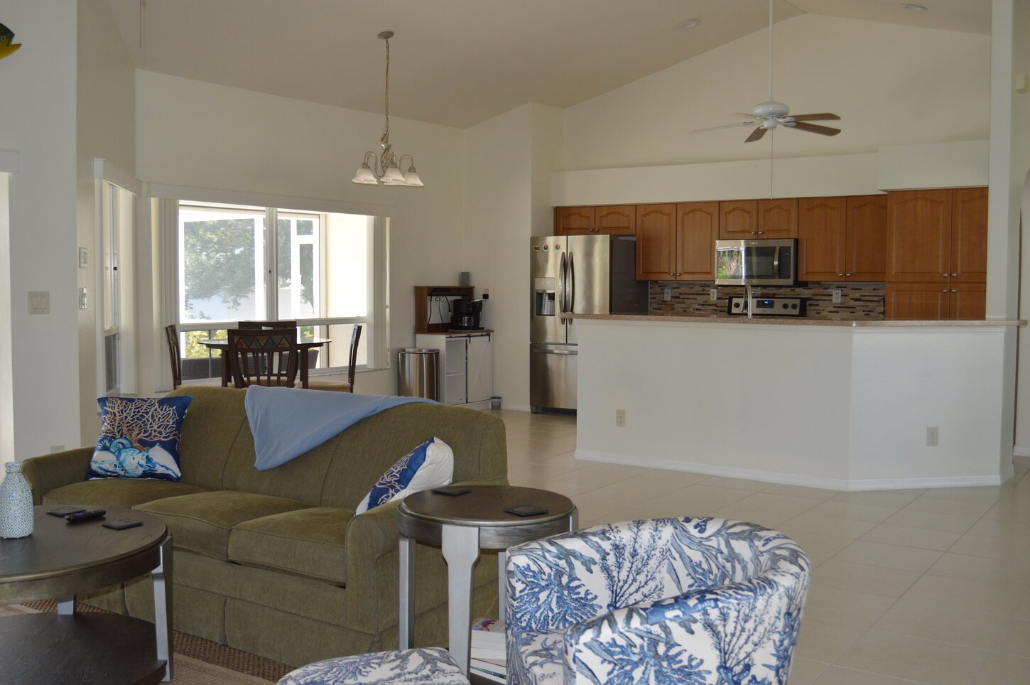 Open-concept living with cozy seating, a spacious kitchen, and plenty of natural light—perfect for relaxing together after a day in the Florida sun.