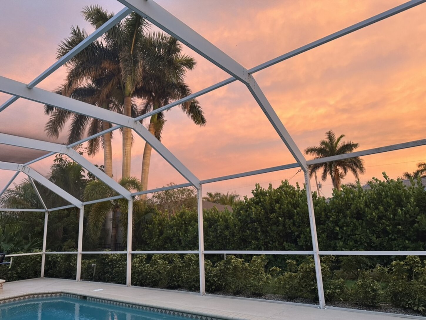 Unwind poolside as the sky paints the perfect Florida sunset.