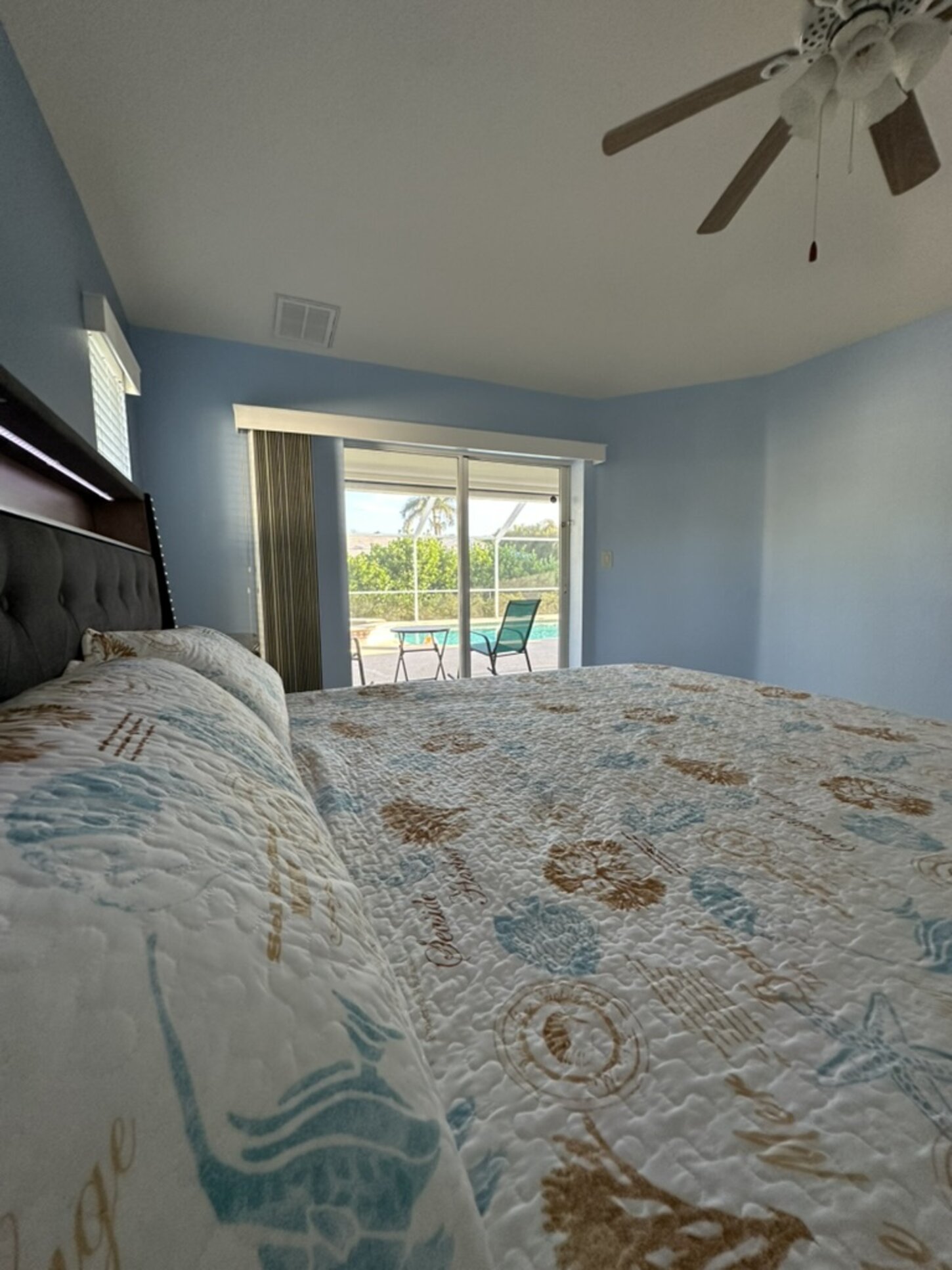Spacious king bedroom with direct lanai access, walk-in closet, and luxurious bath with jetted tub, walk-in shower, and dual vanities.
