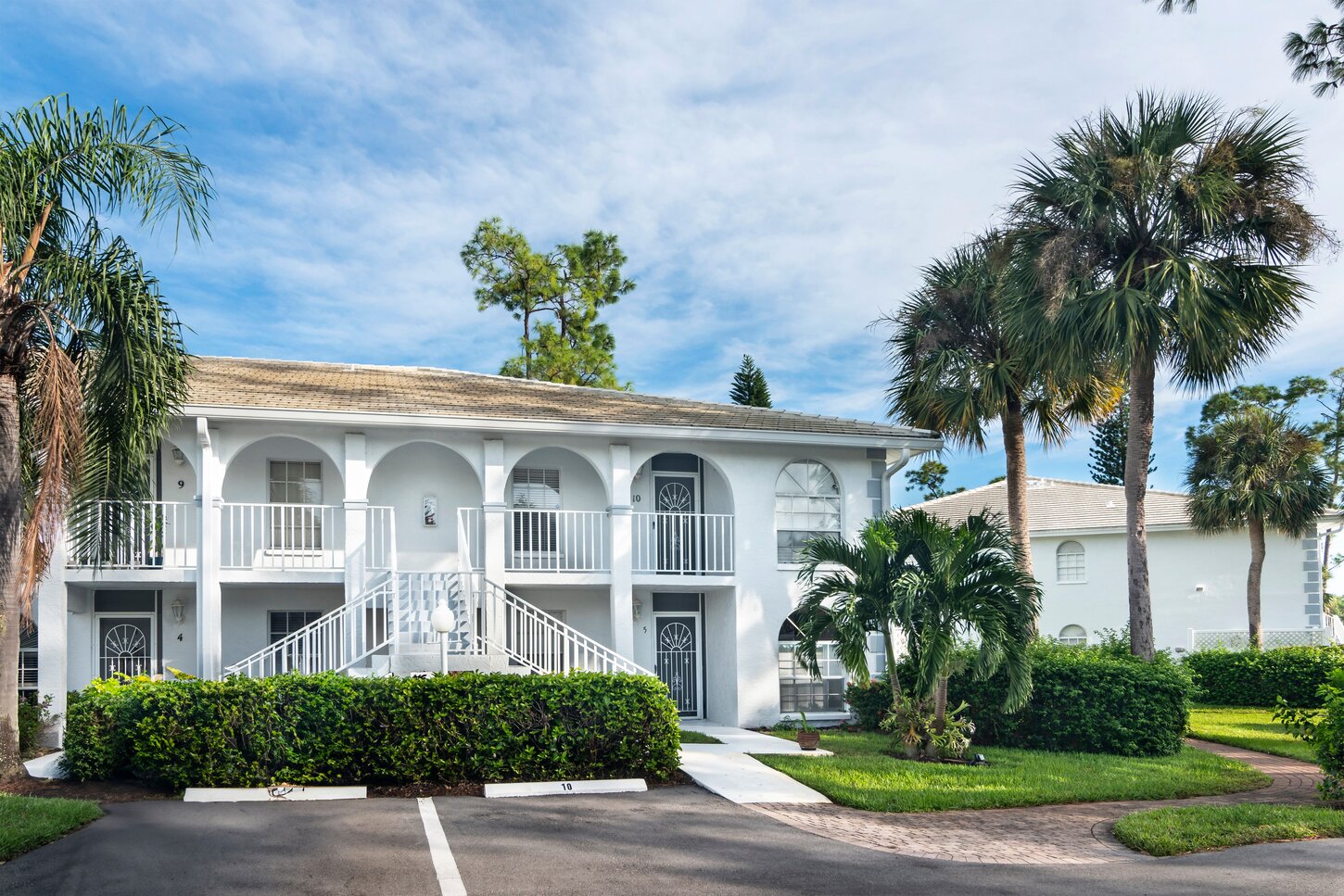 Main entrance to the second floor condo to the top right with your private parking spot right out front.