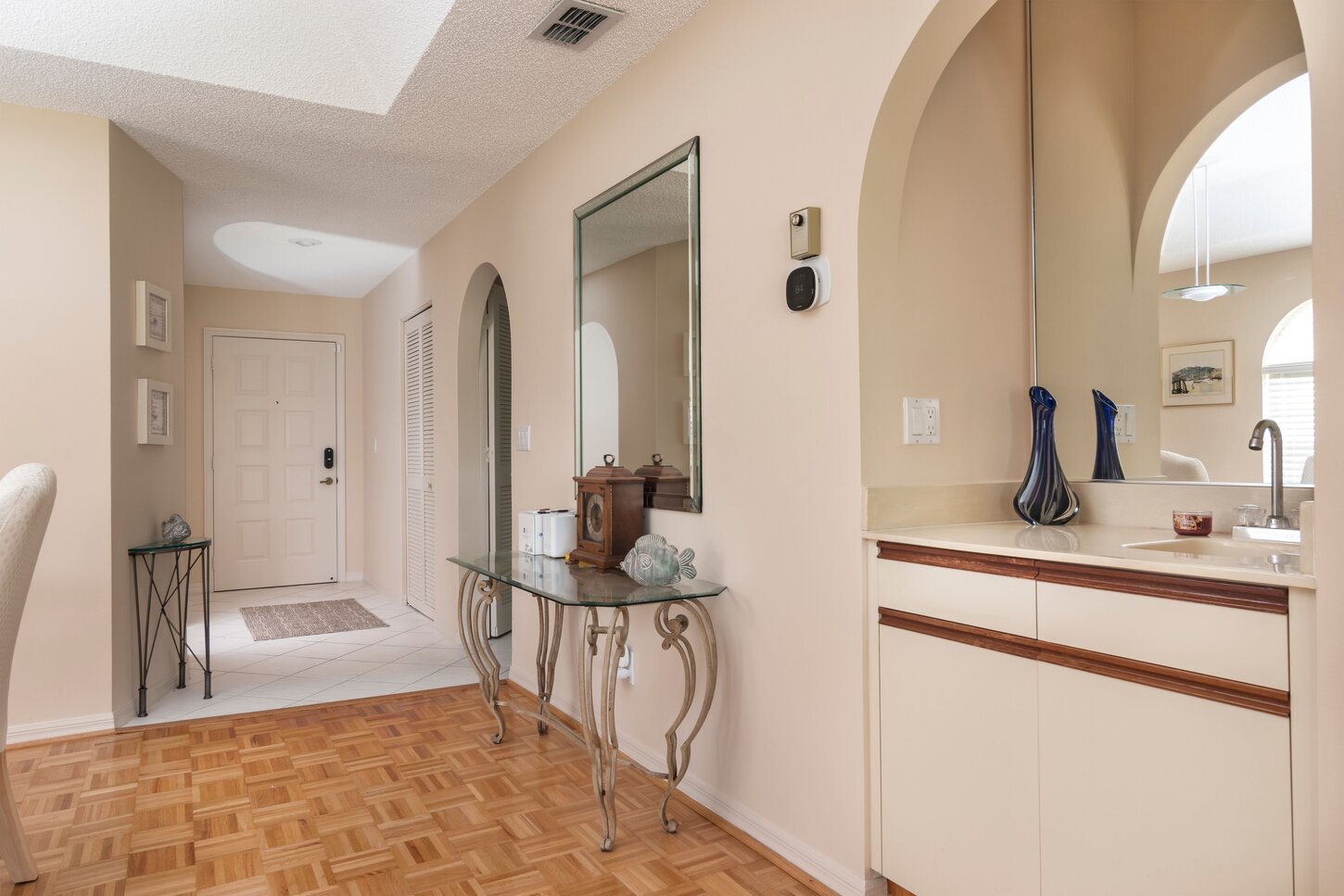 Looking towards the entry with a bar top to the right and a formal Dining Table and chairs.