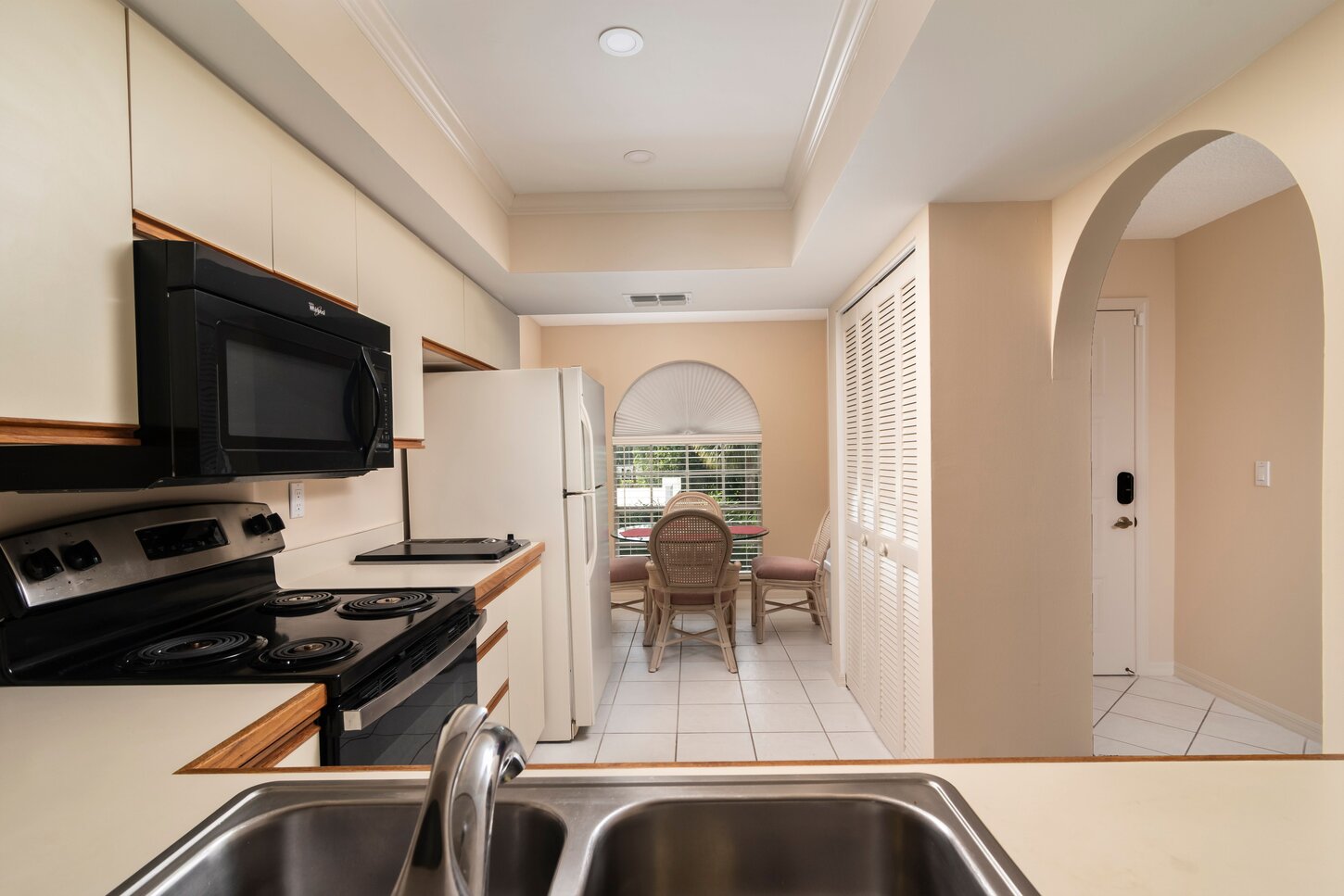 Looking into the kitchen dining area with a pantry to the right.
