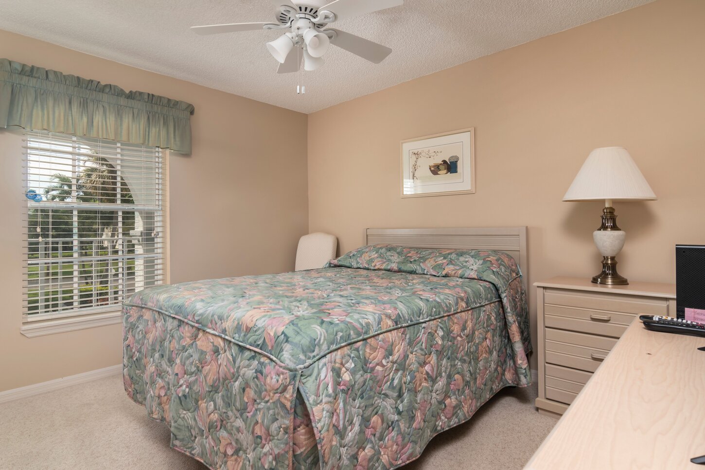Guest bedroom with a Queen size bed, Smart TV with a desk work station.