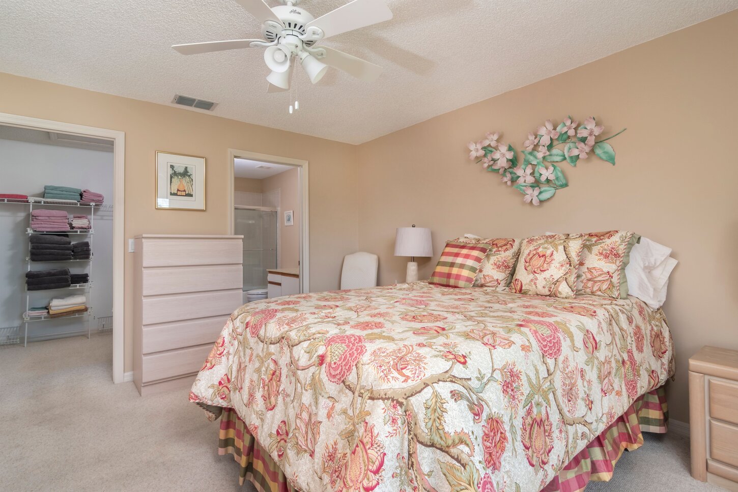 Master bedroom with a queen bed walk in closet two dressers and a Smart Tv for streaming