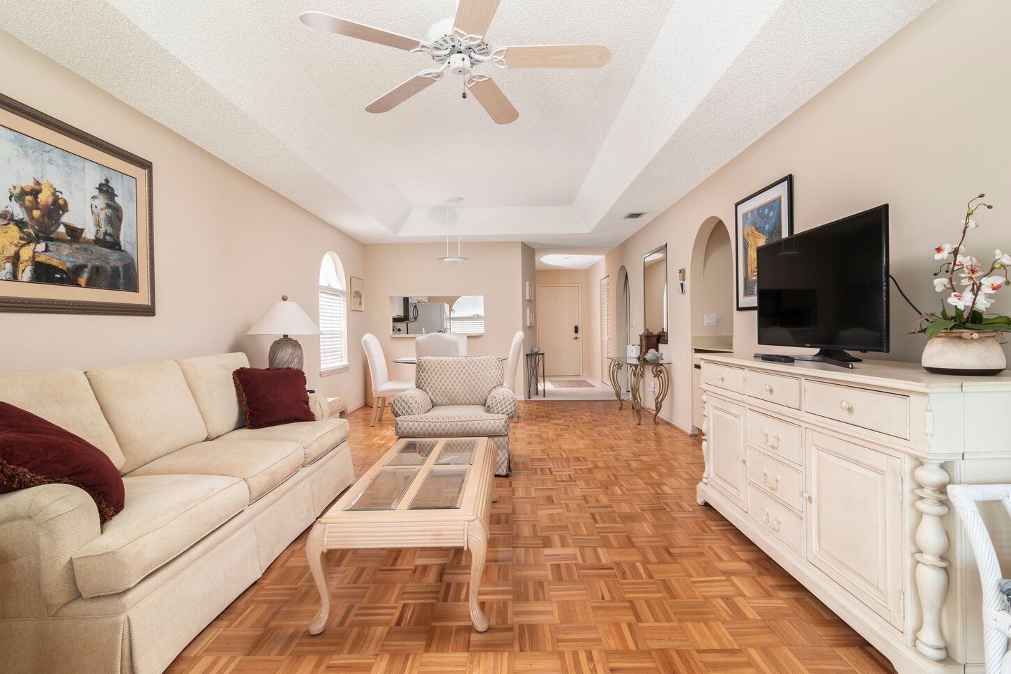 Livingroom / Great Room with a vaulted ceiling with a remote fan.Smart TV for streaming.