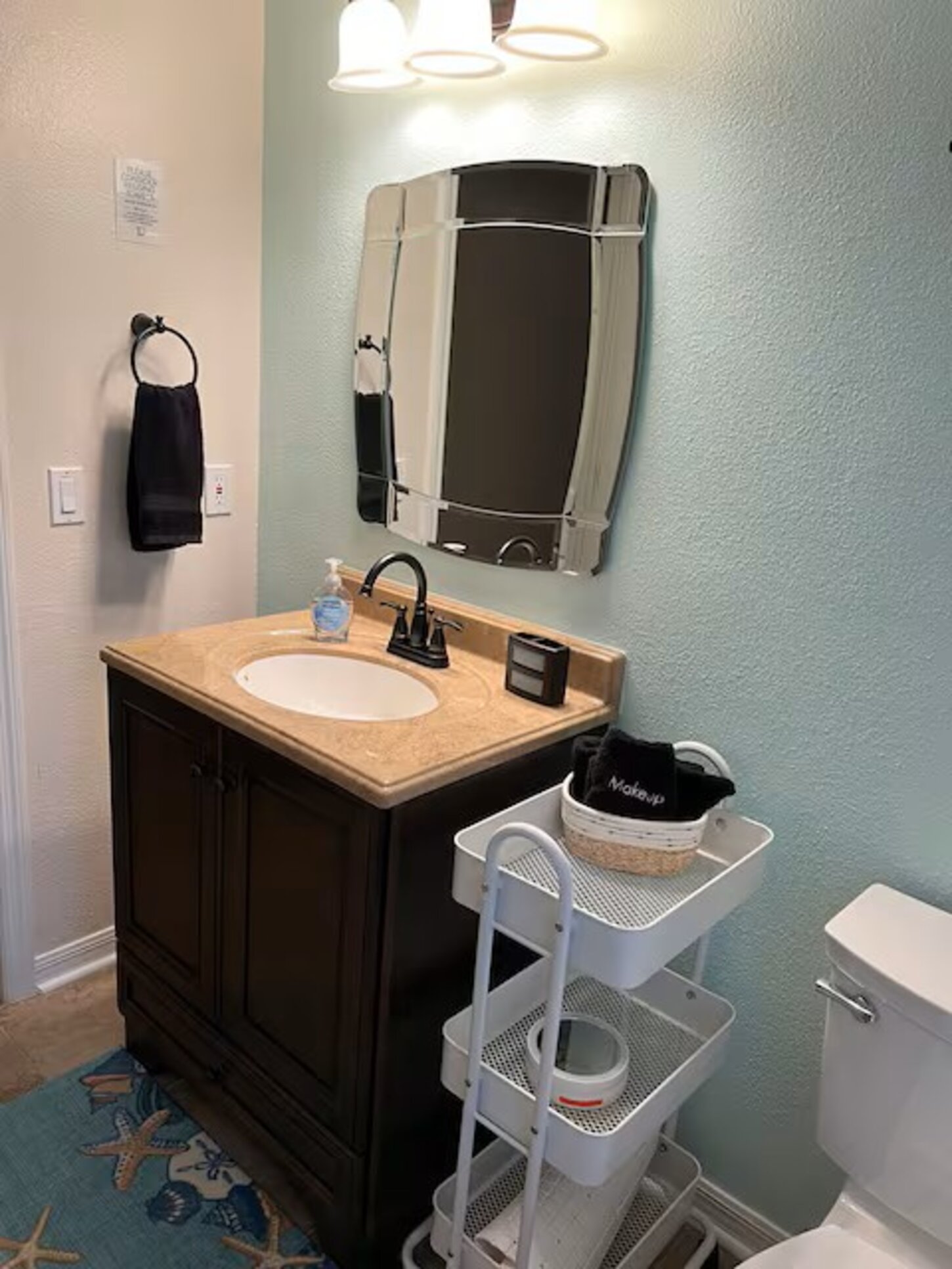 Bathroom #2. Plenty room to move around and lots of storage with shelves and under cabinet. Linen closet just outside the door with plenty of quality towels. 
