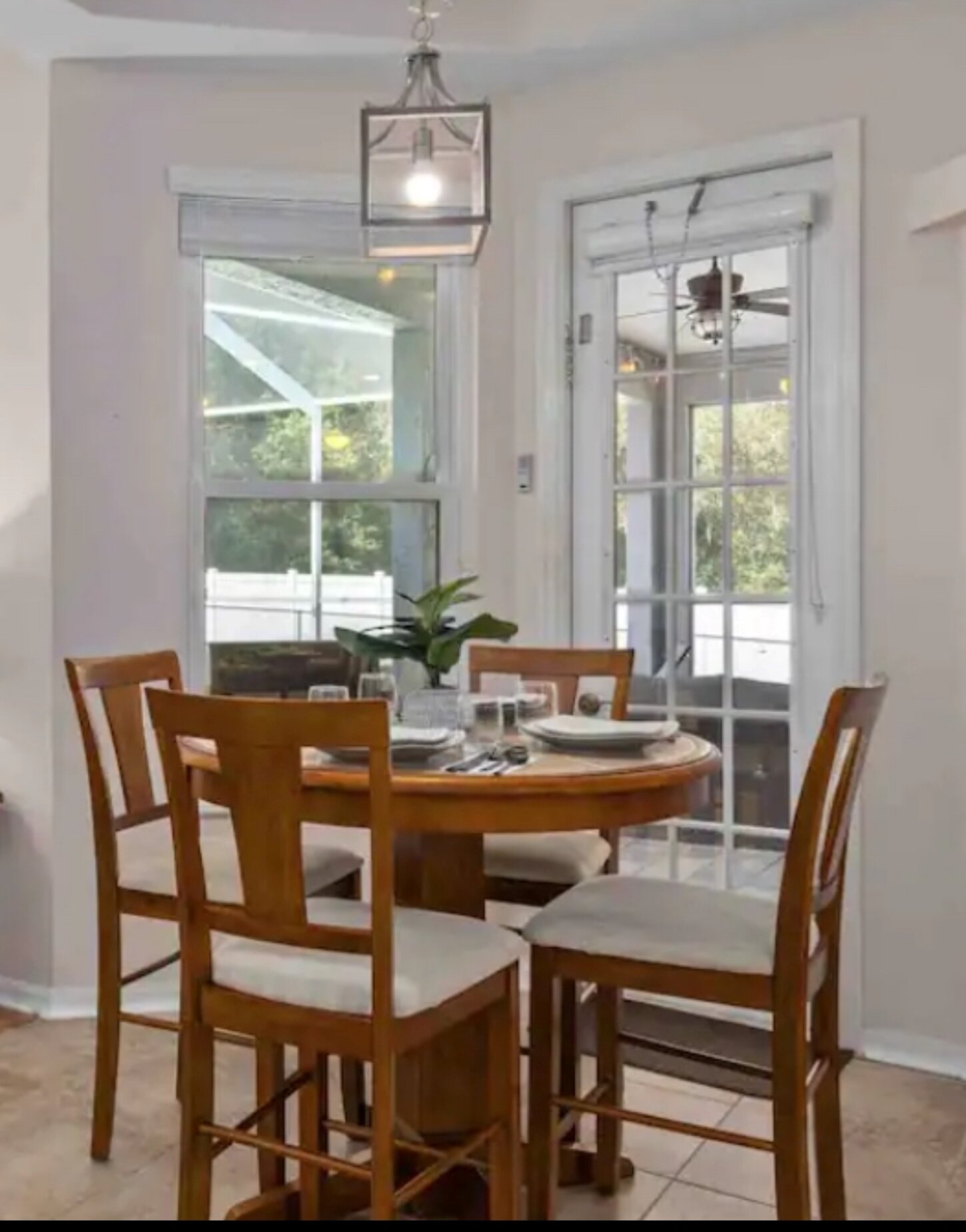 High top table and chairs for a cozy meal for 4 over looking the patio, pool, and backyard. 