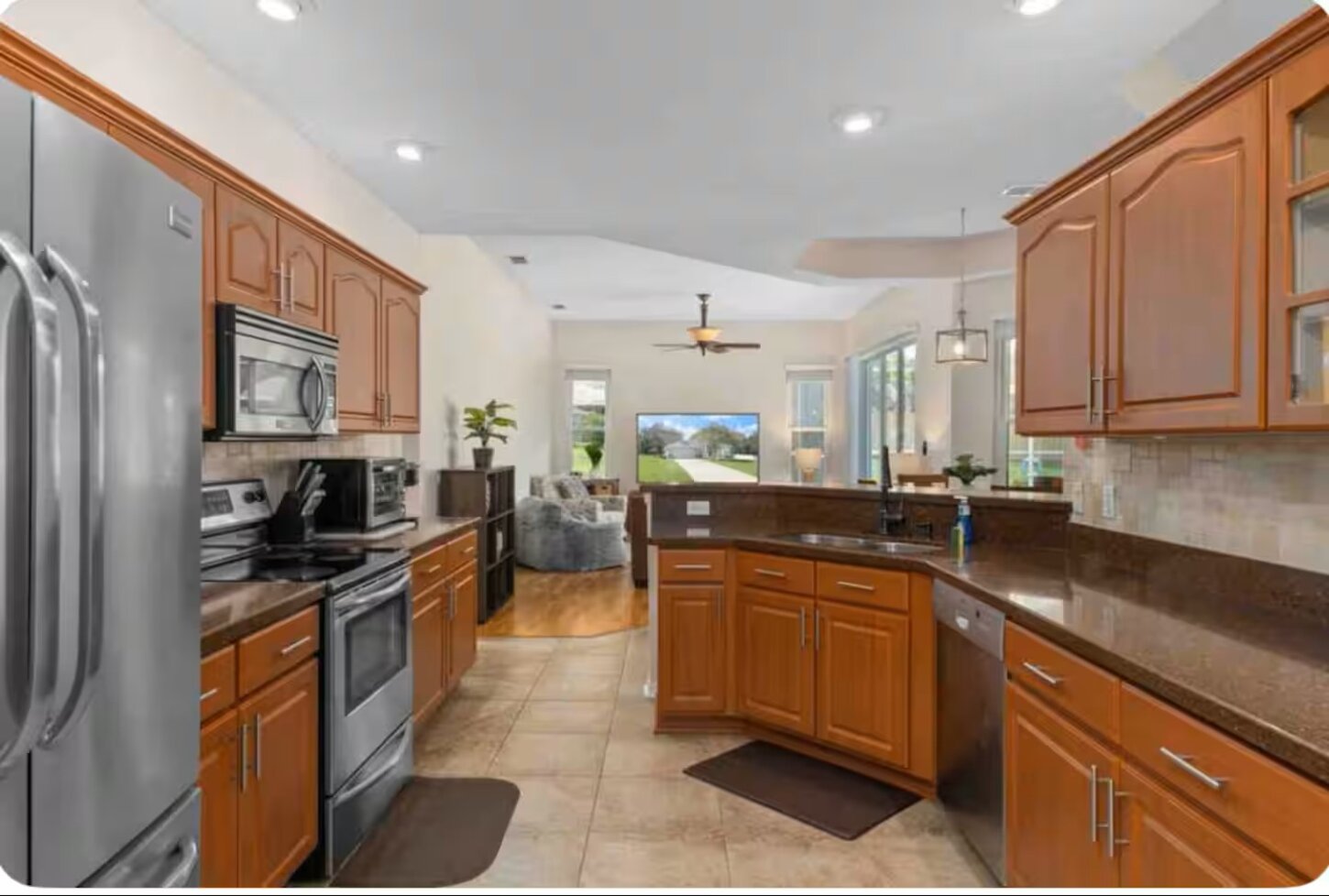 There's room to move around in this beautiful kitchen. All the amenities of home. Enjoy an oversized refrigerator, dishwasher, oven, and microwave. Kitchen stocked with basic needs, cooking utensils, coffee pots, electric kettle & small appliances.  